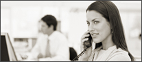 woman at desk at computer on phone